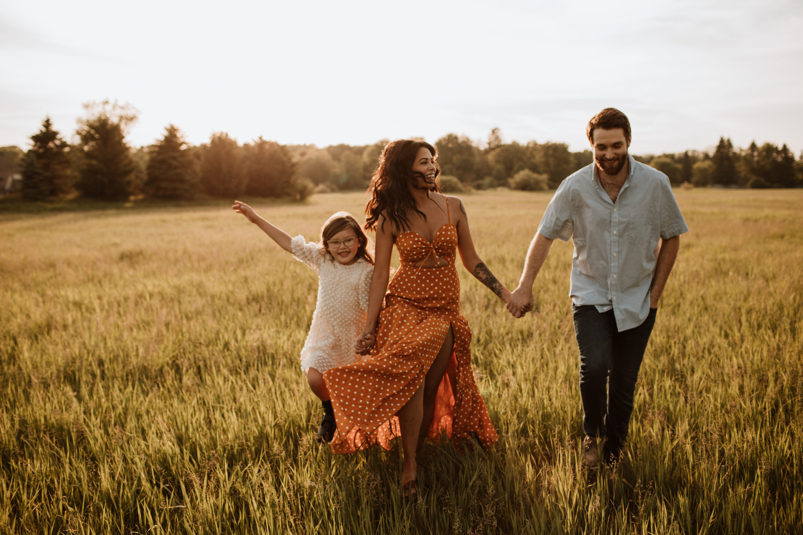 family running through a field sunset michigan